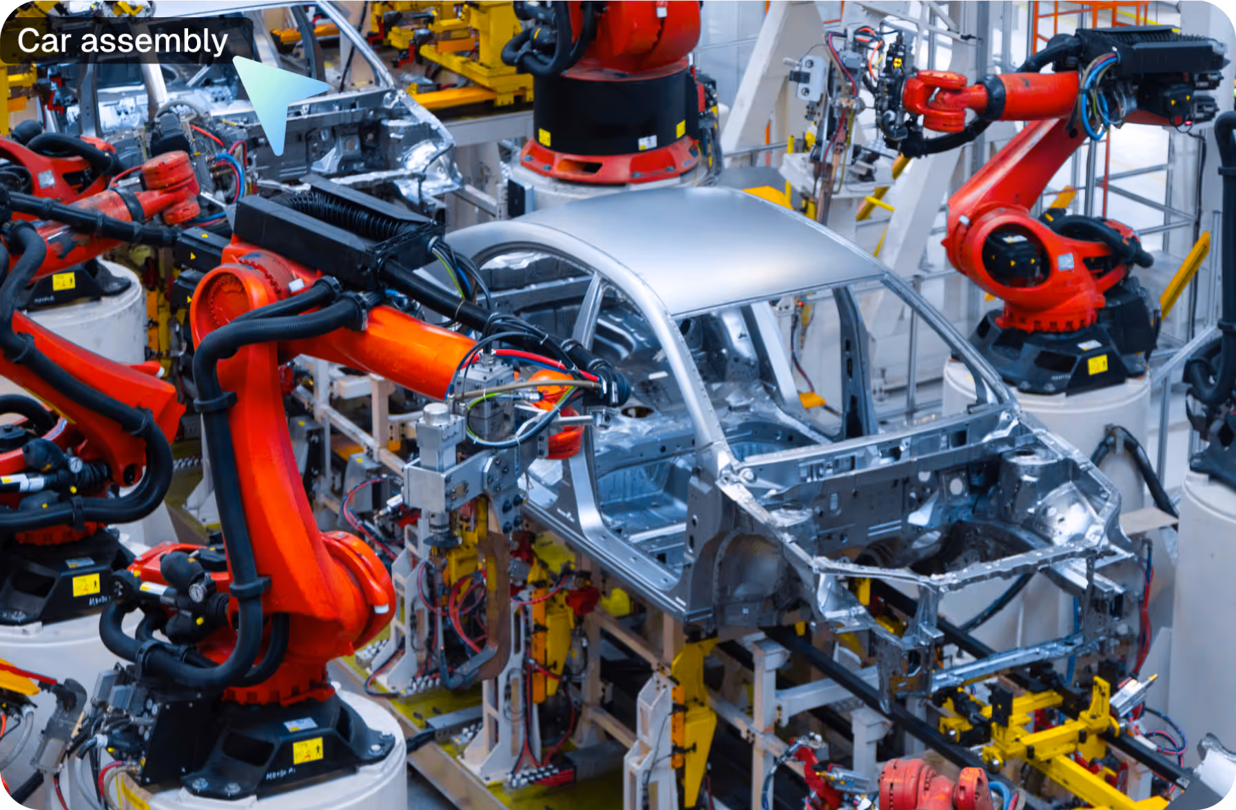 Robotic arms assembling car body frames on an automated automotive production line.