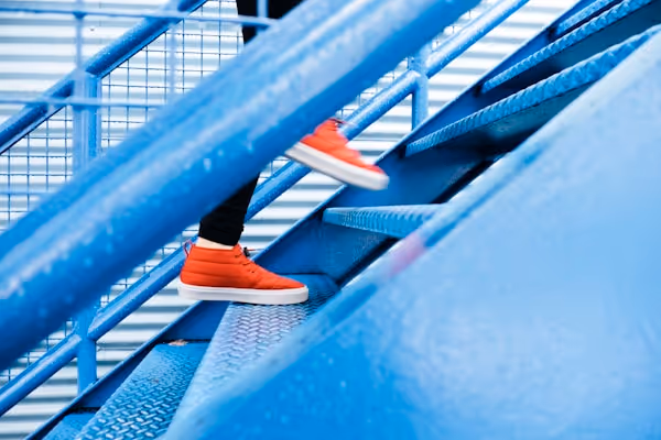 person stepping on blue stairs