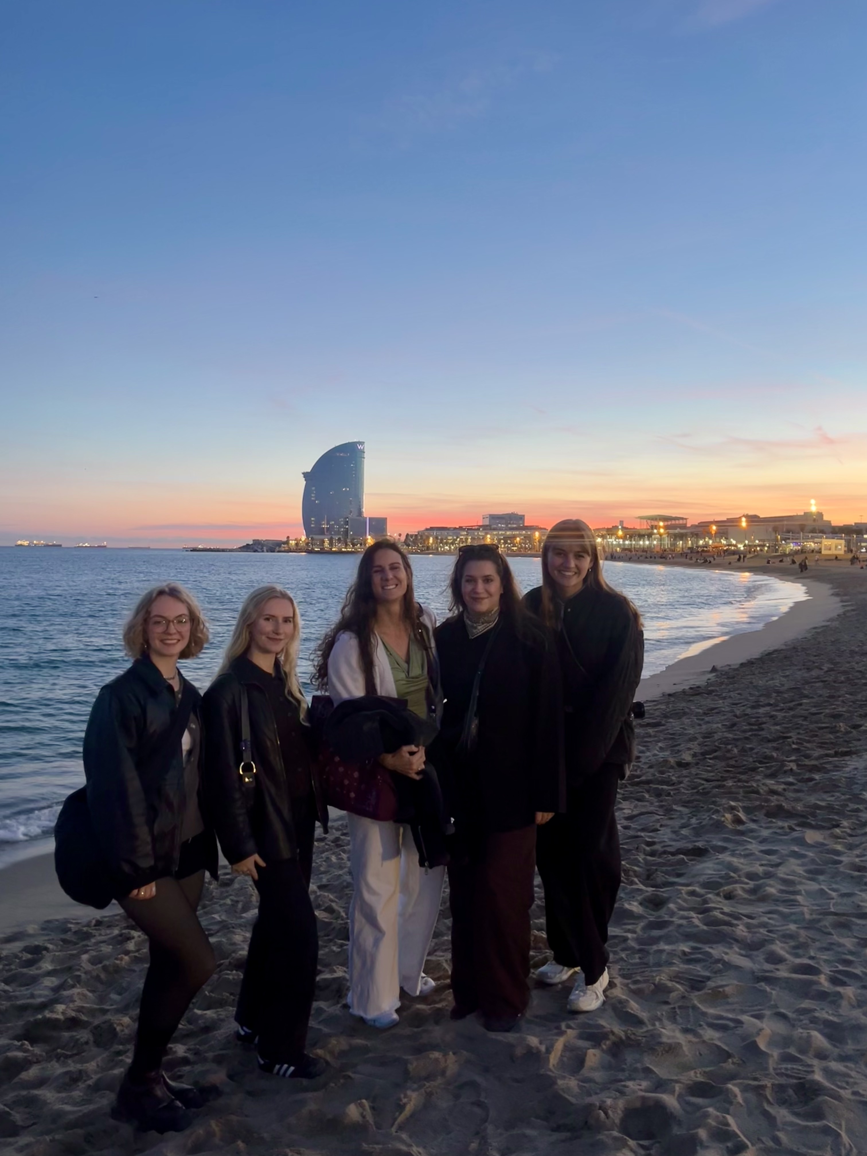 The andamp team on workation in Barcelona enjoying a sunset at the beach