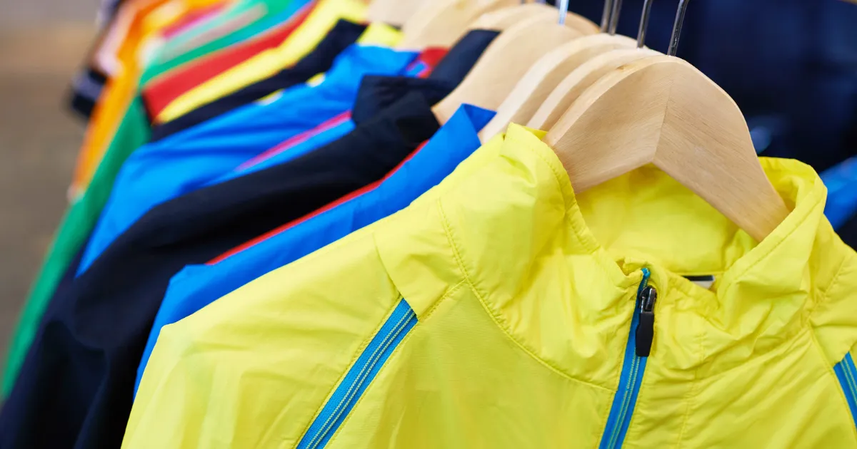 Collection of custom sportswear on hangers.