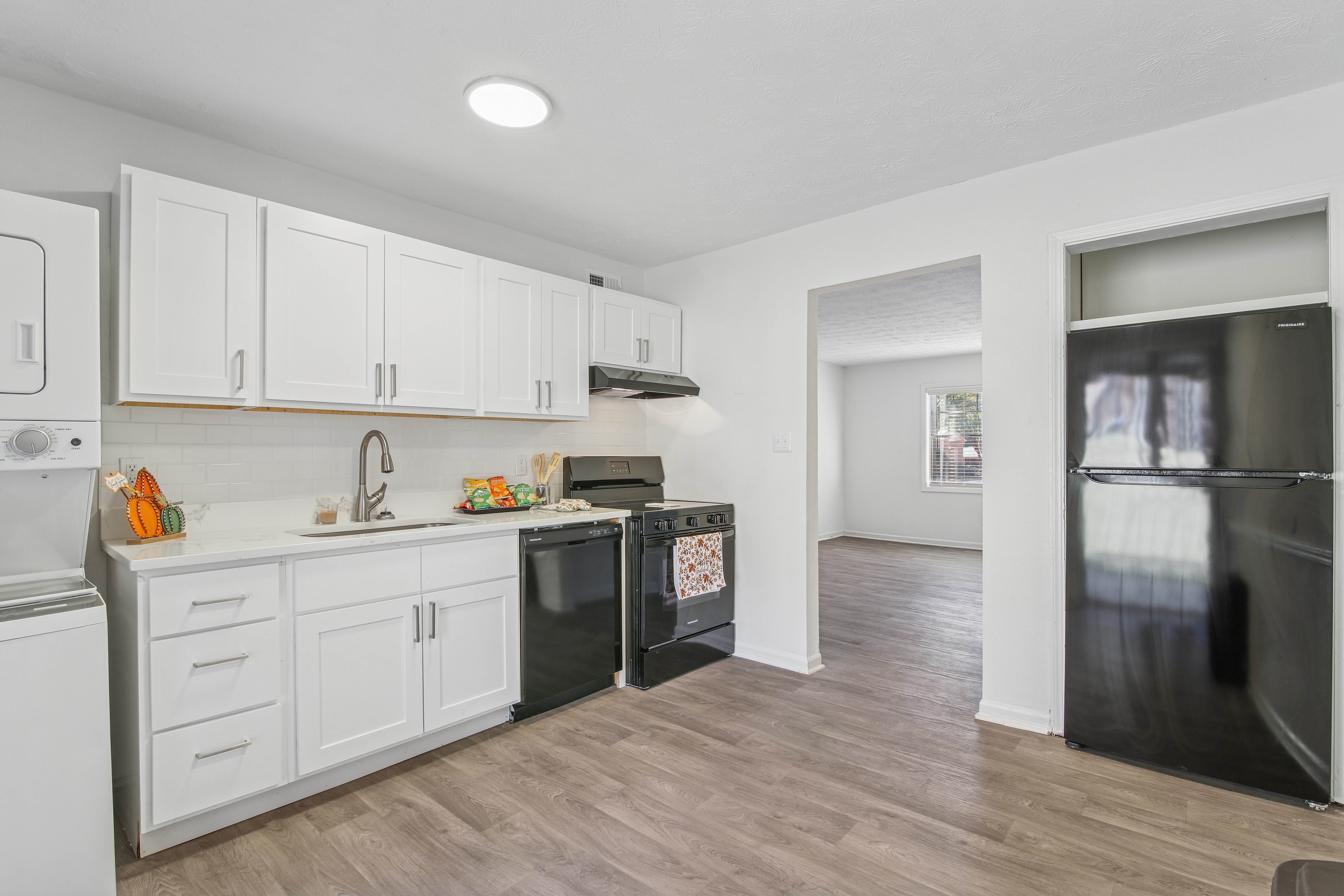kitchen with white cabinets and black appliances