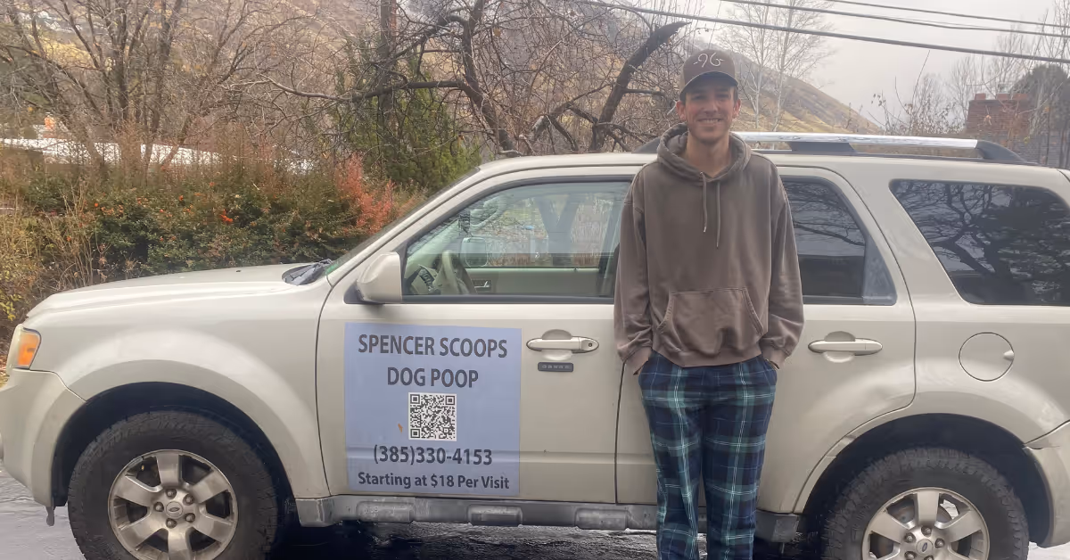 Spencer standing by his poop scooping mobile