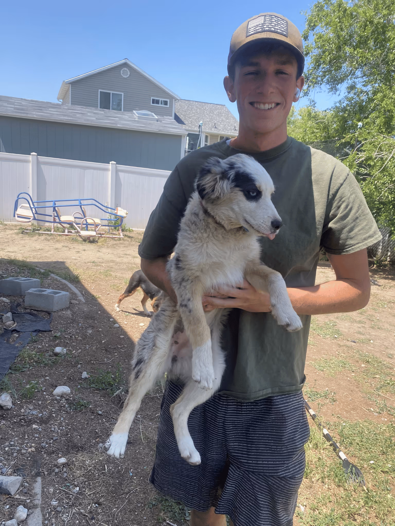 Spencer's Scoops employee holding a puppy at a customer's home in Magna, Utah