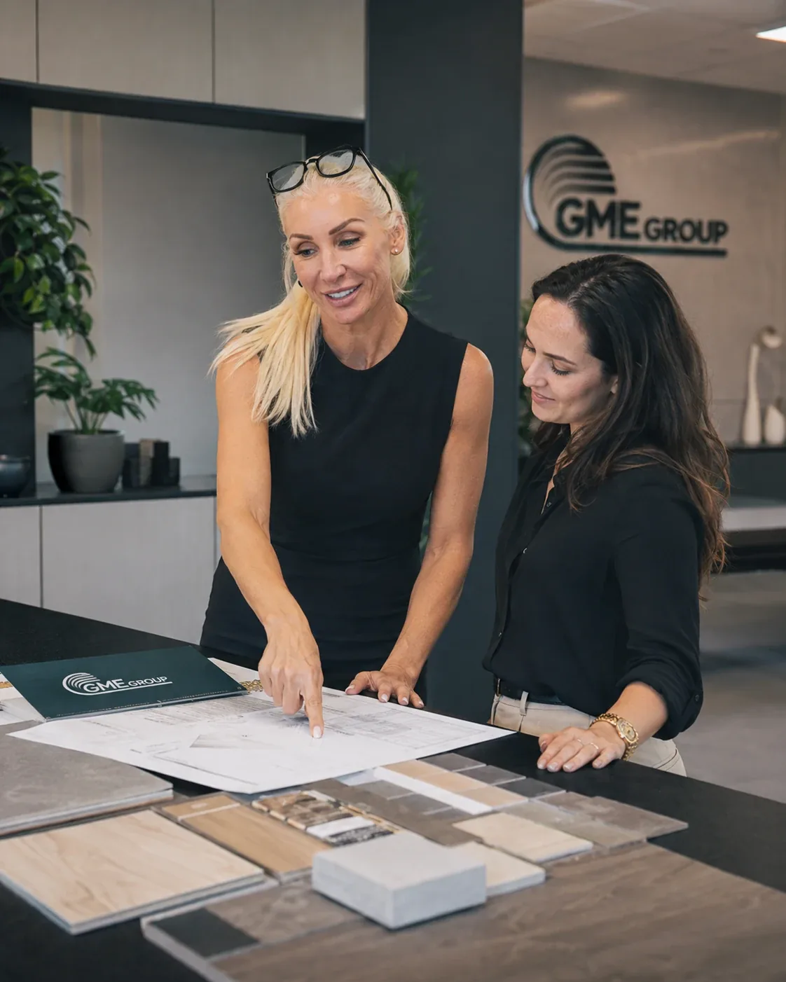 GME Group team reviewing plans and material samples in the office