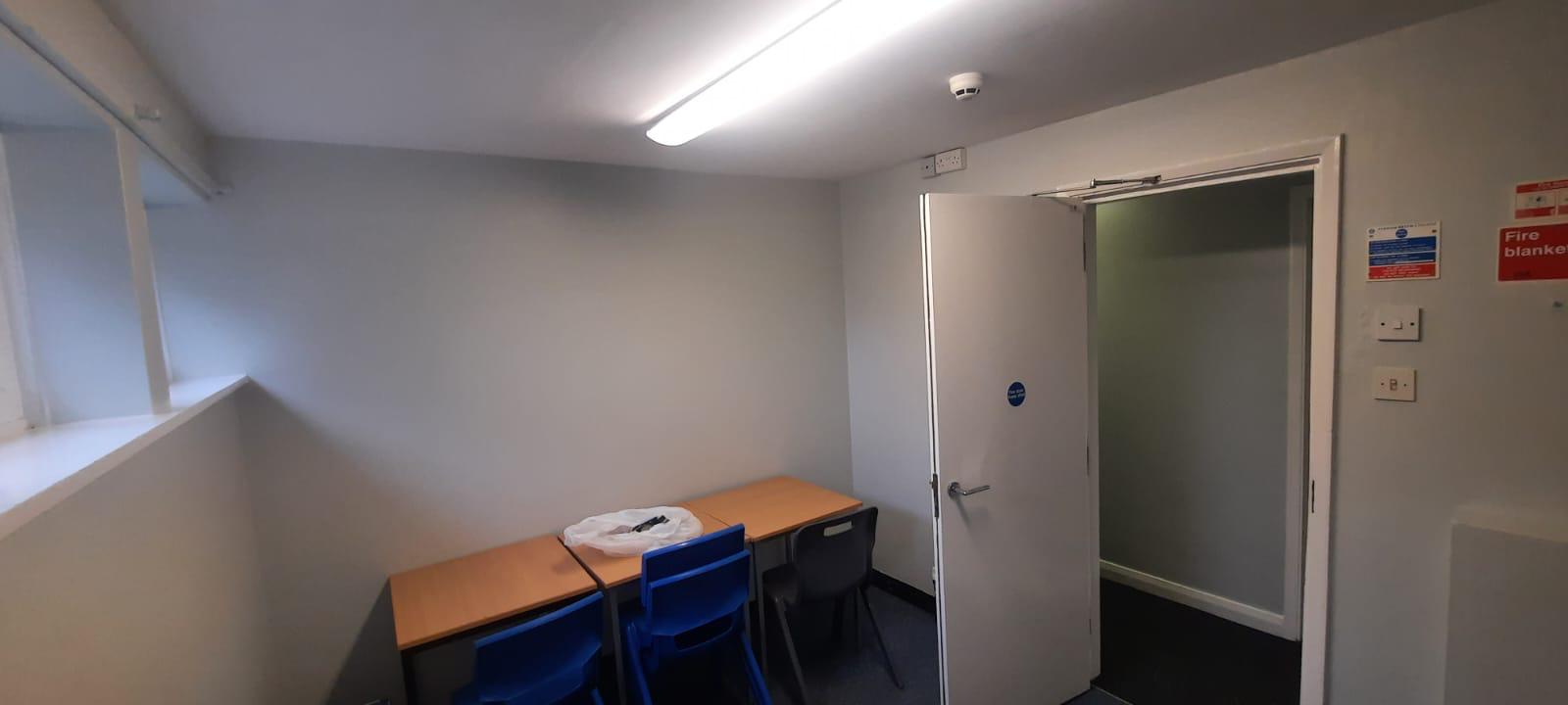 Refurbished study room in university accommodation with new table and chairs