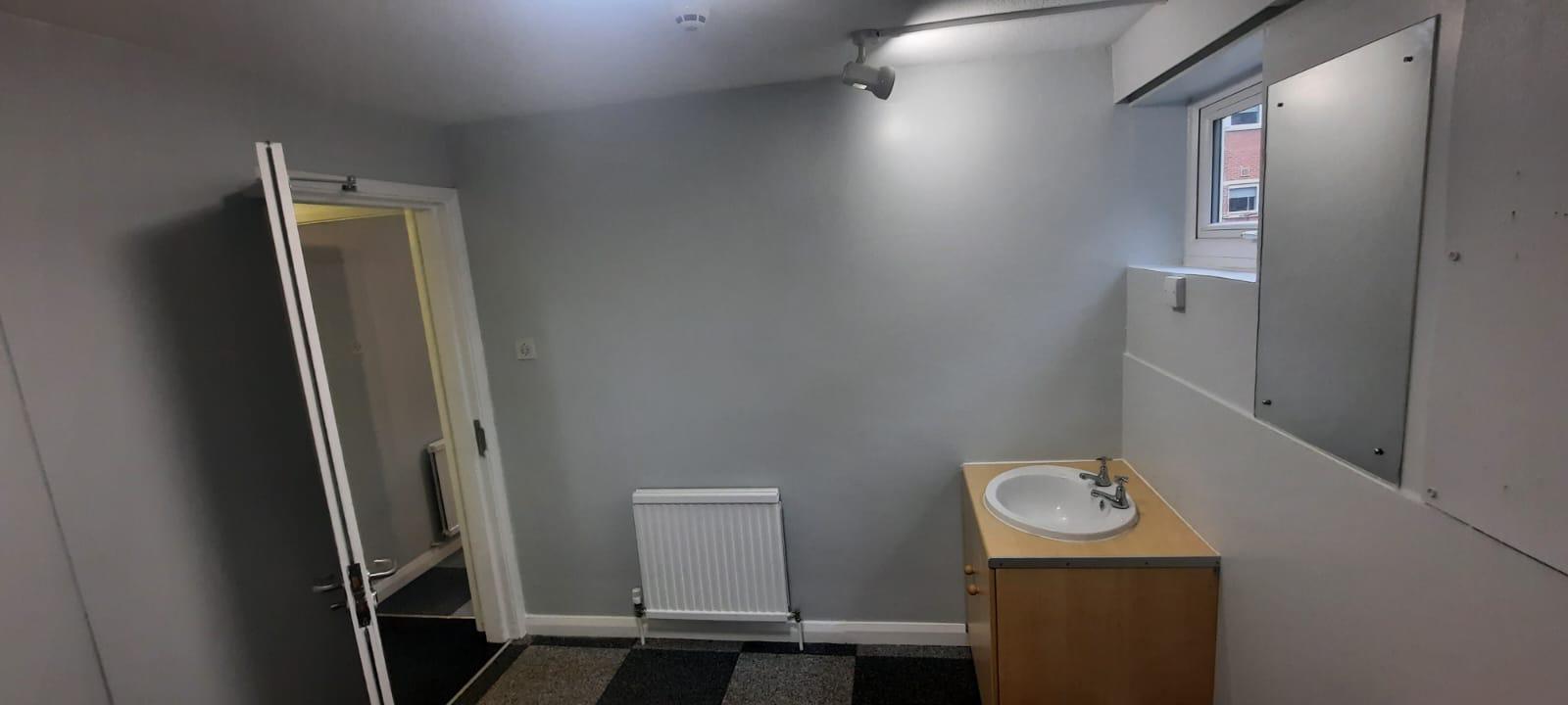 University accommodation room with fitted vanity unit and new carpet tiles