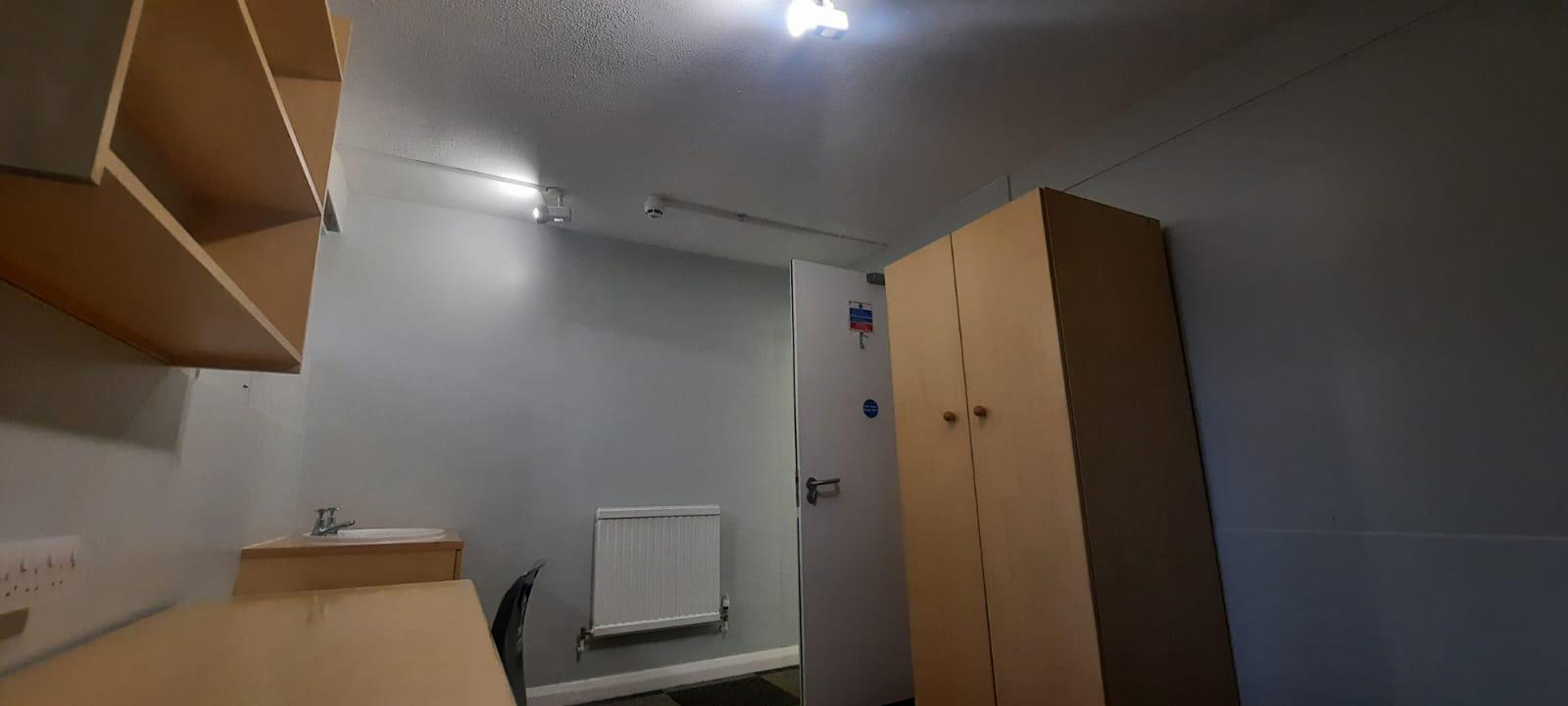 Student bedroom with fitted wardrobe and desk after refurbishment