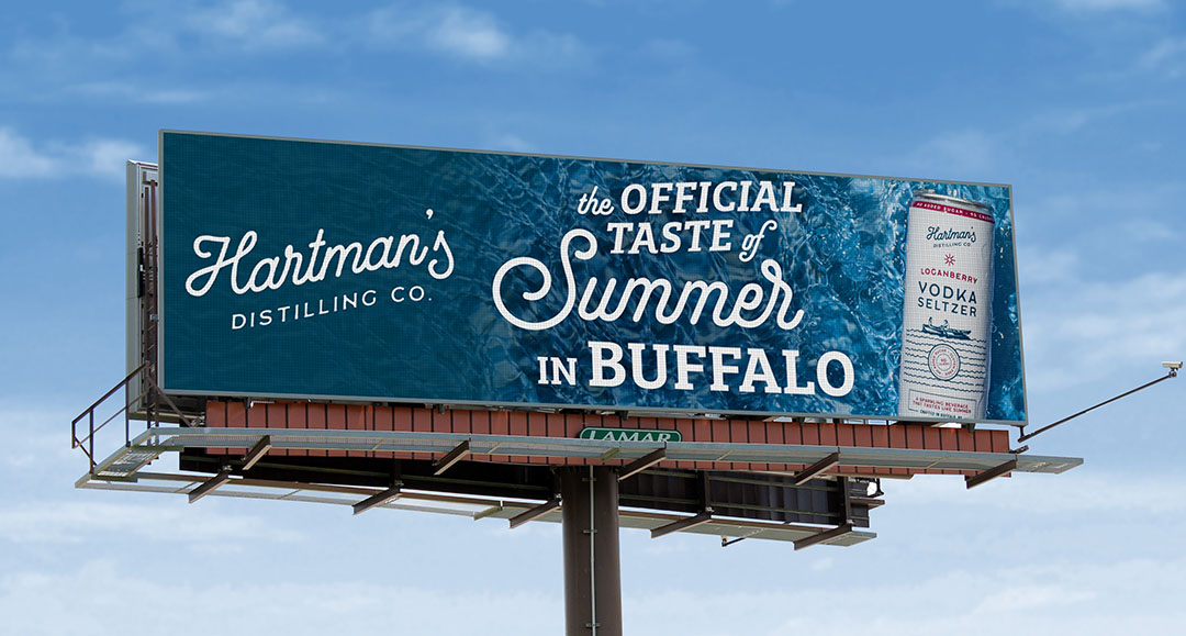 A billboard advertising the Loganberry flavor of Hartman's Distilling vodka seltzer