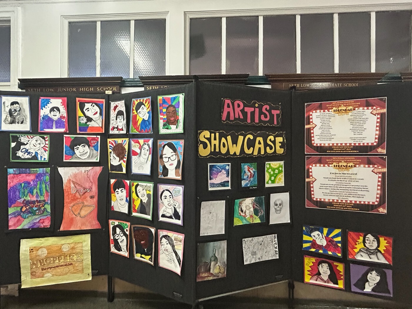 Student artwork displayed on boards at Seth Low Junior High School Artist Showcase