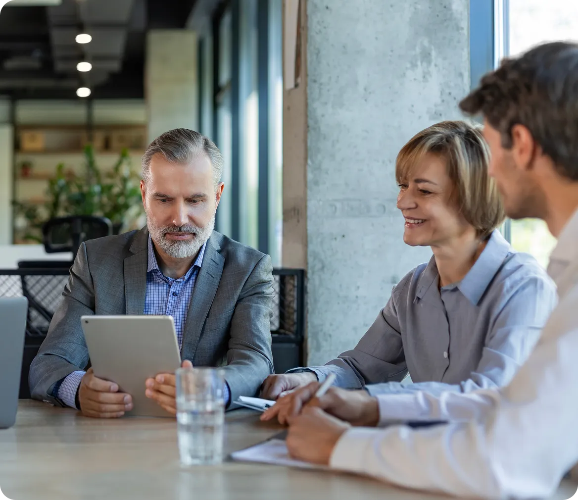 Two women sitting on the floor looking at a piece of paper.