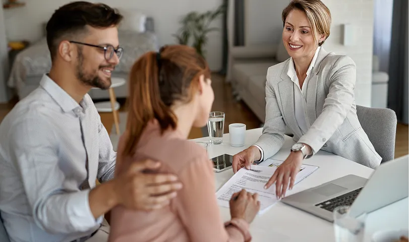 A couple of women standing next to each other holding boxes.