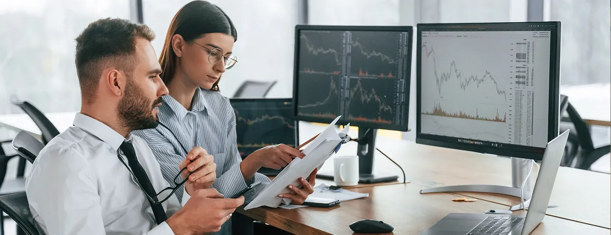 A man and a woman looking at a laptop.