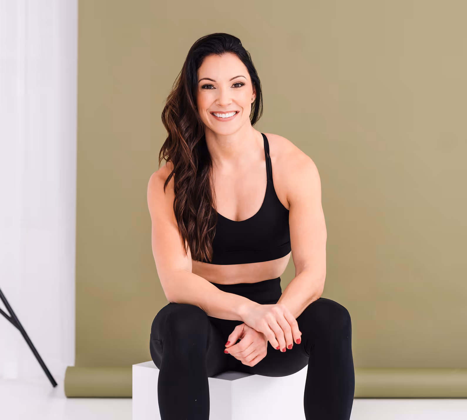 A woman sitting on top of a white box.