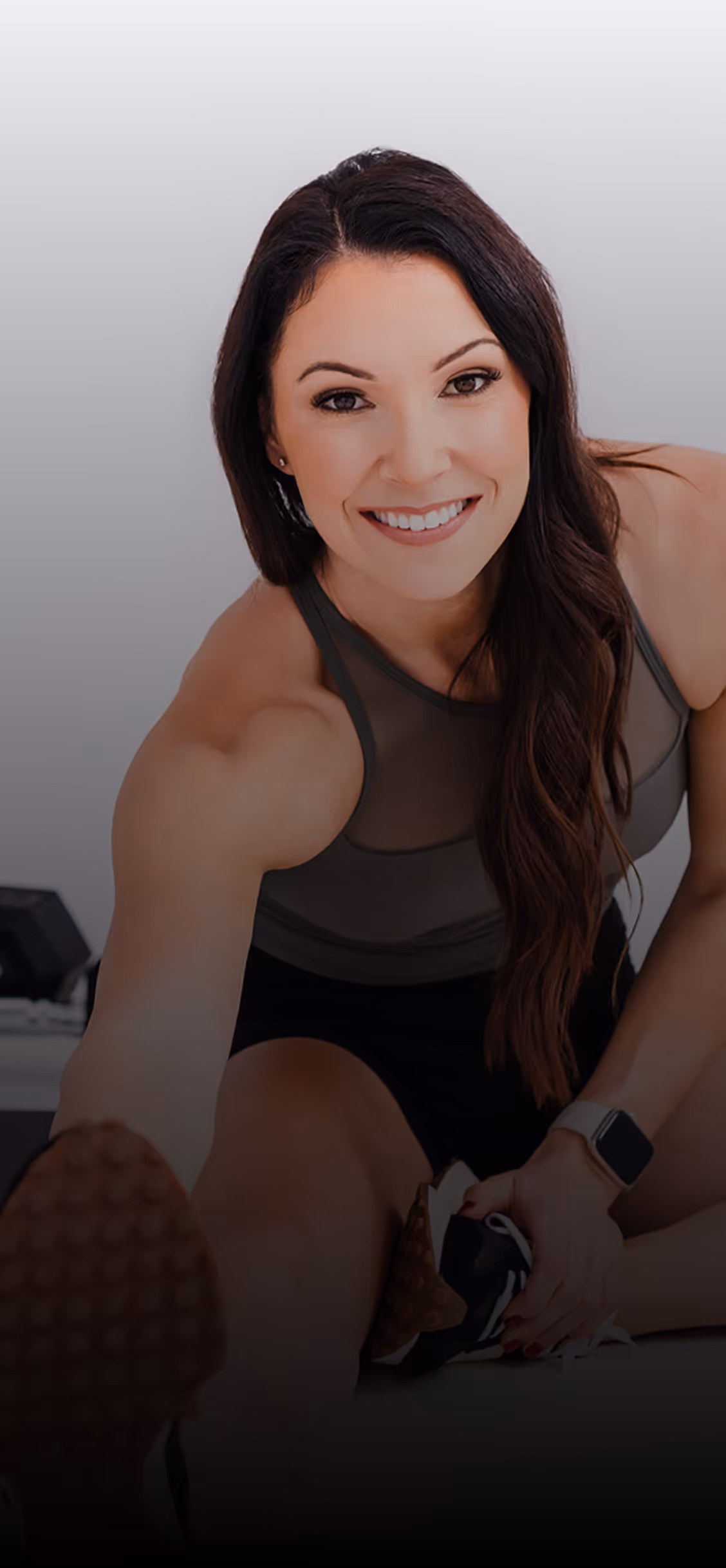 A woman is smiling and posing for a picture.