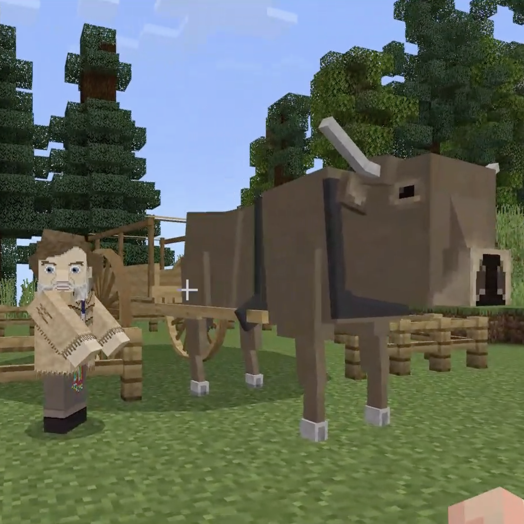 Minecraft scene with a pixelated ox pulling a wooden cart and a character standing beside it in a grassy area with trees.