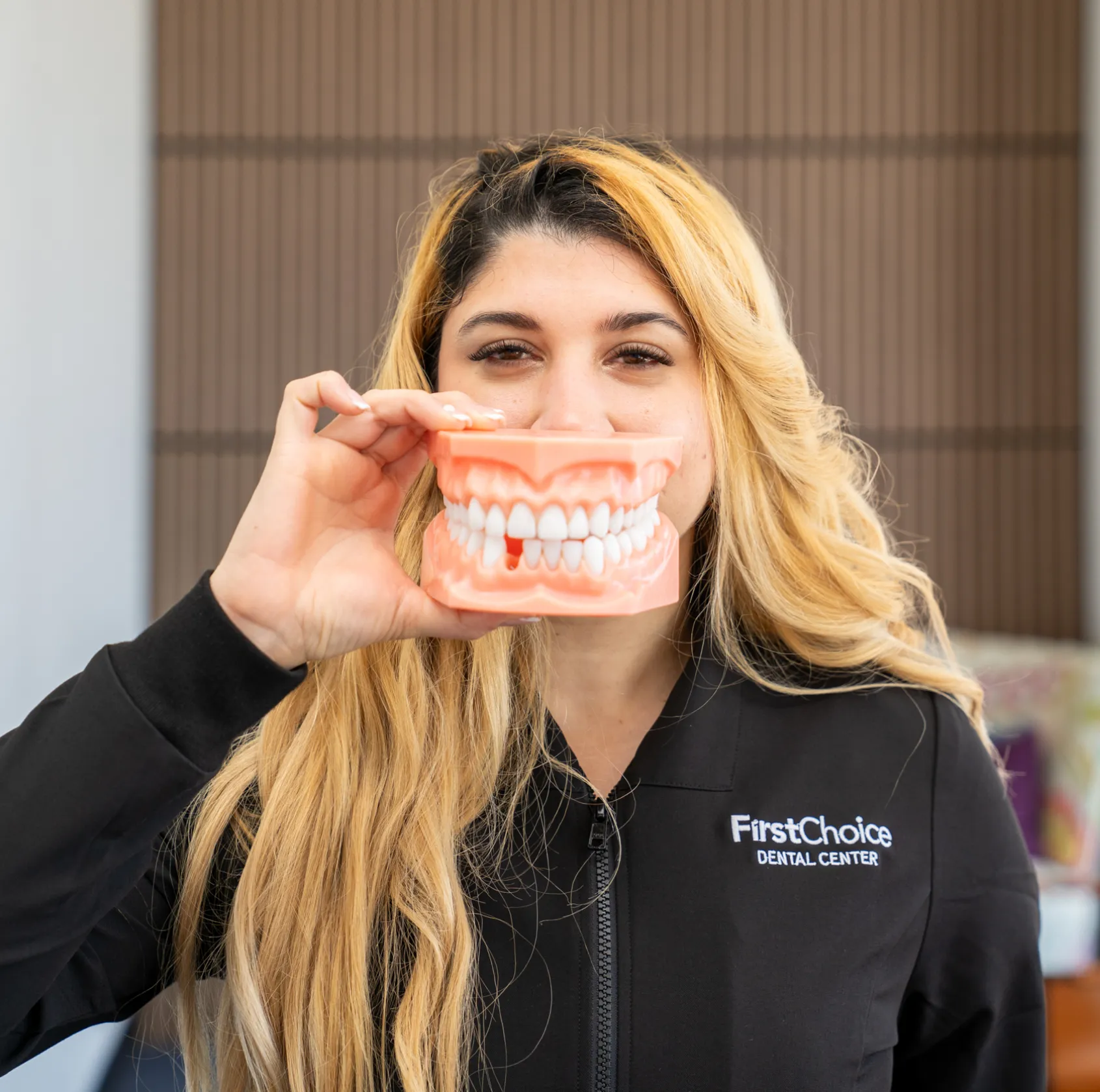 Woman holding a denture