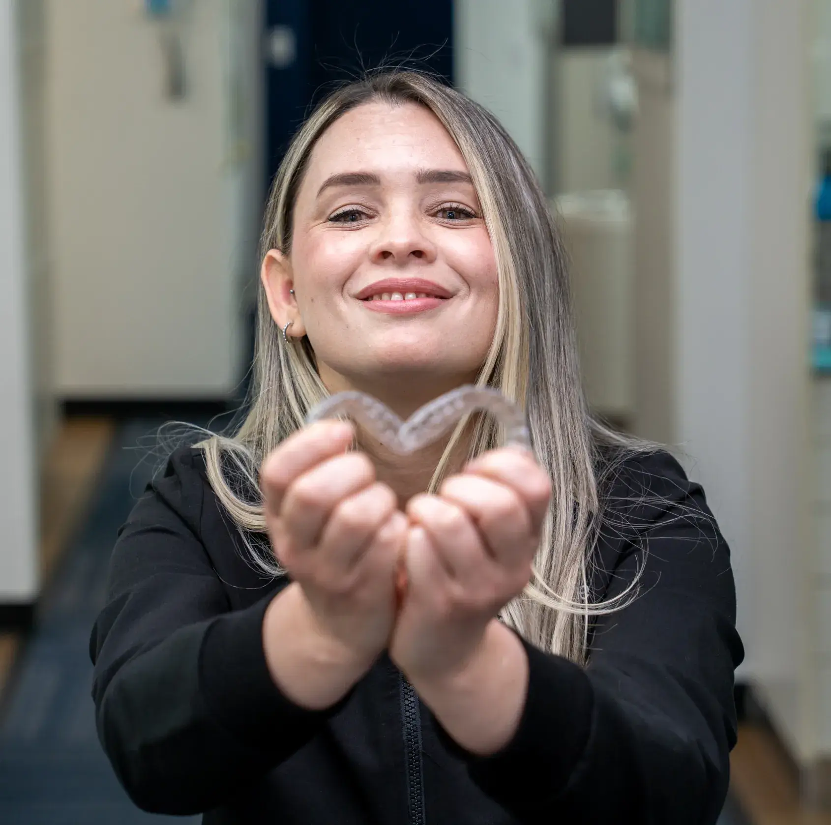 Woman holding clear aligners trays