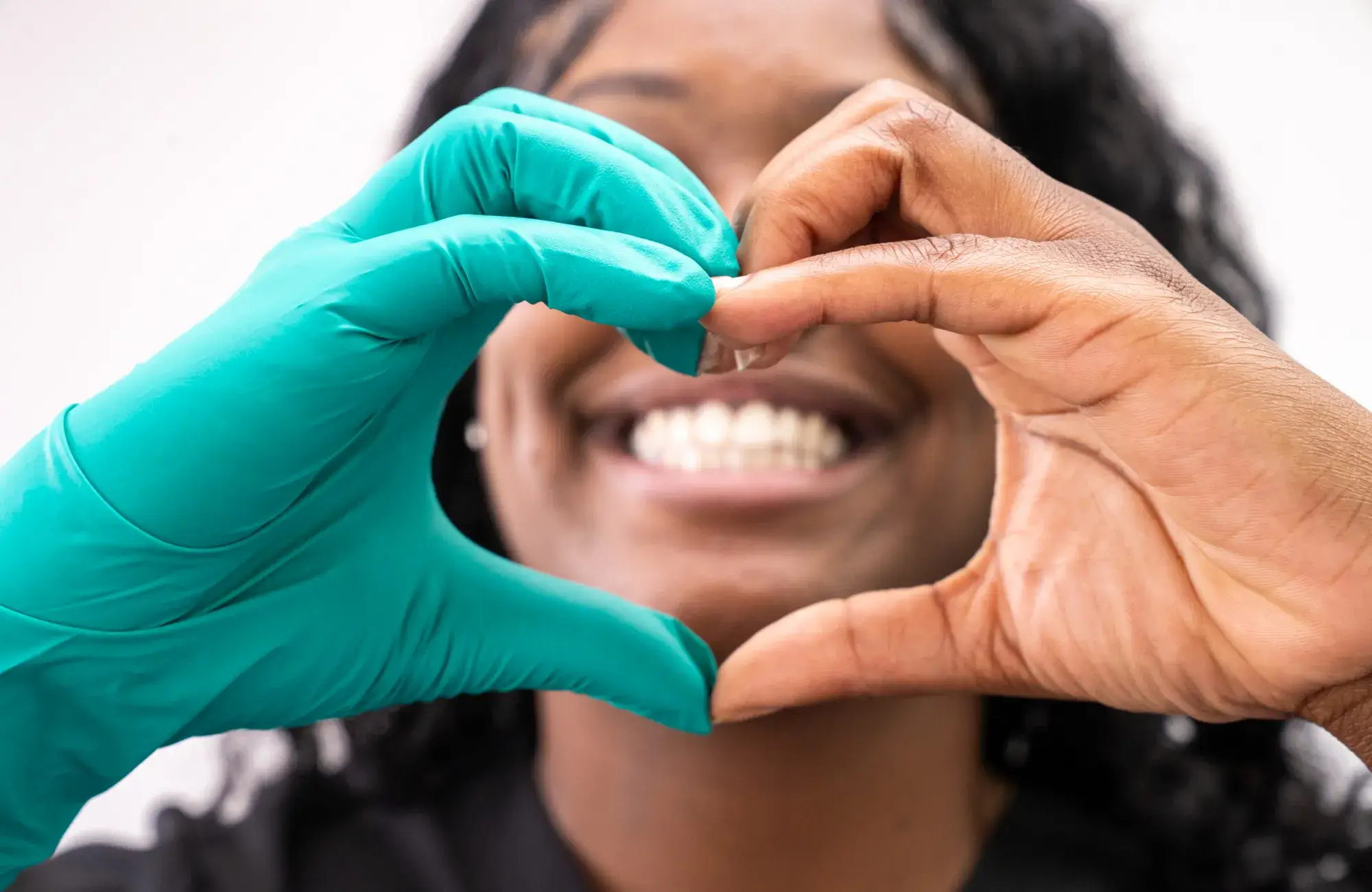 Woman doing a heart with ther hands