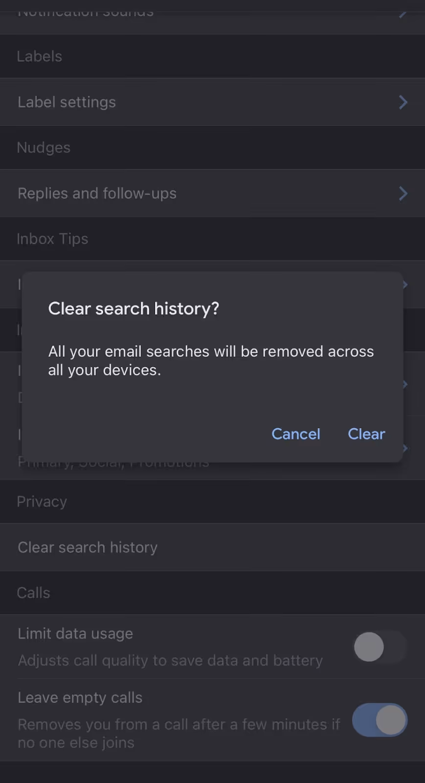 A screenshot of the UI inside the Settings section of the Gmail app in iPhone, showing a pop-up window confirming the deletion of all email searches