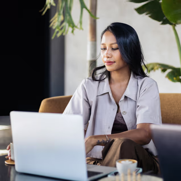 Woman sitting down looking at laptop