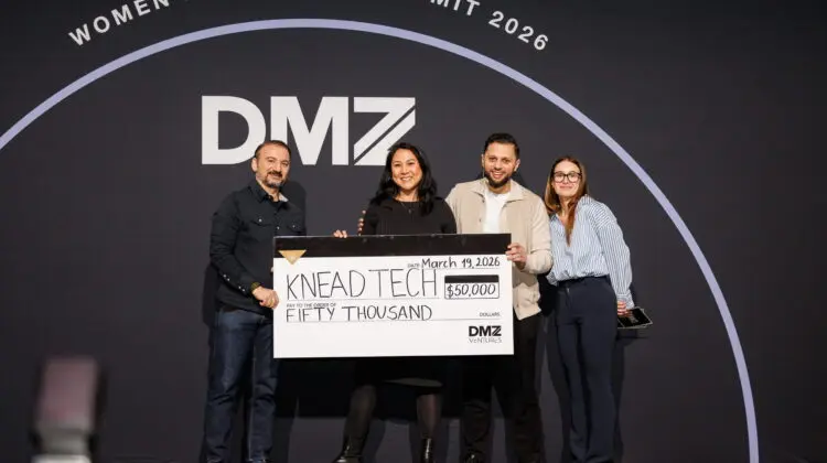 A group of people receiving a cheque on stage at the DMZ Women Innovation SUmmit 2026.