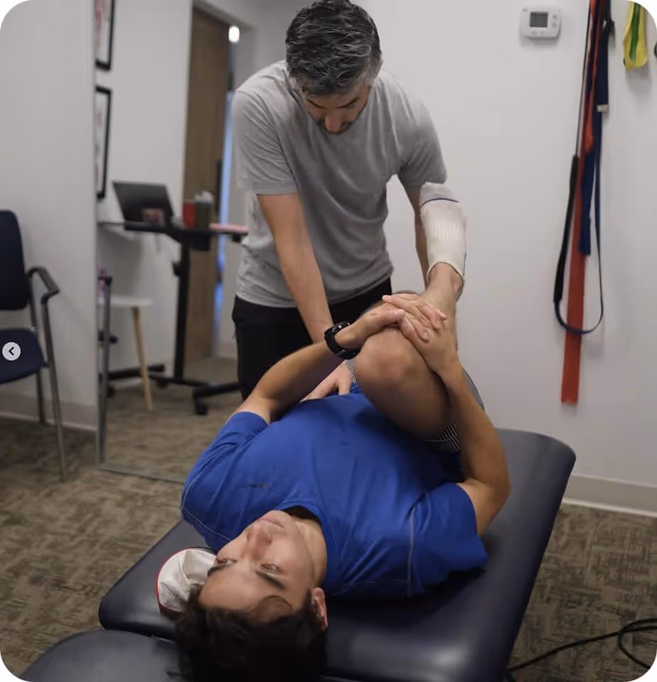 Physical therapist assessing patient for chronic back pain in Washington DC clinic