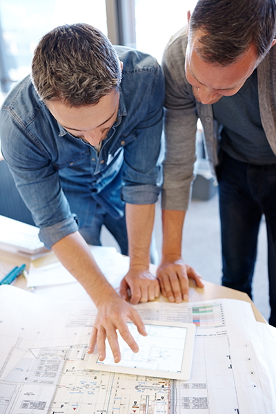 Two construction executives looking at estimates