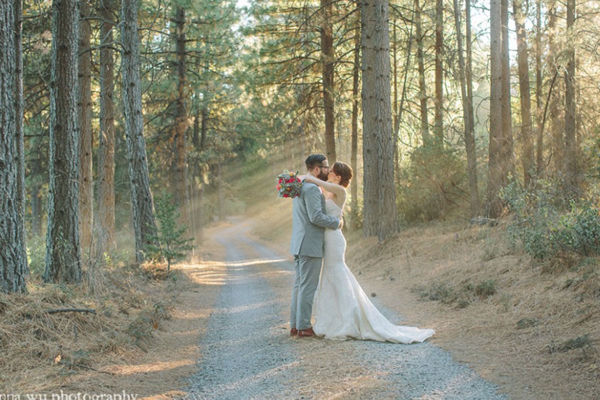 Wedding couple sharing a kiss overlooking the Sierra Nevada mountains at Forest House Lodge