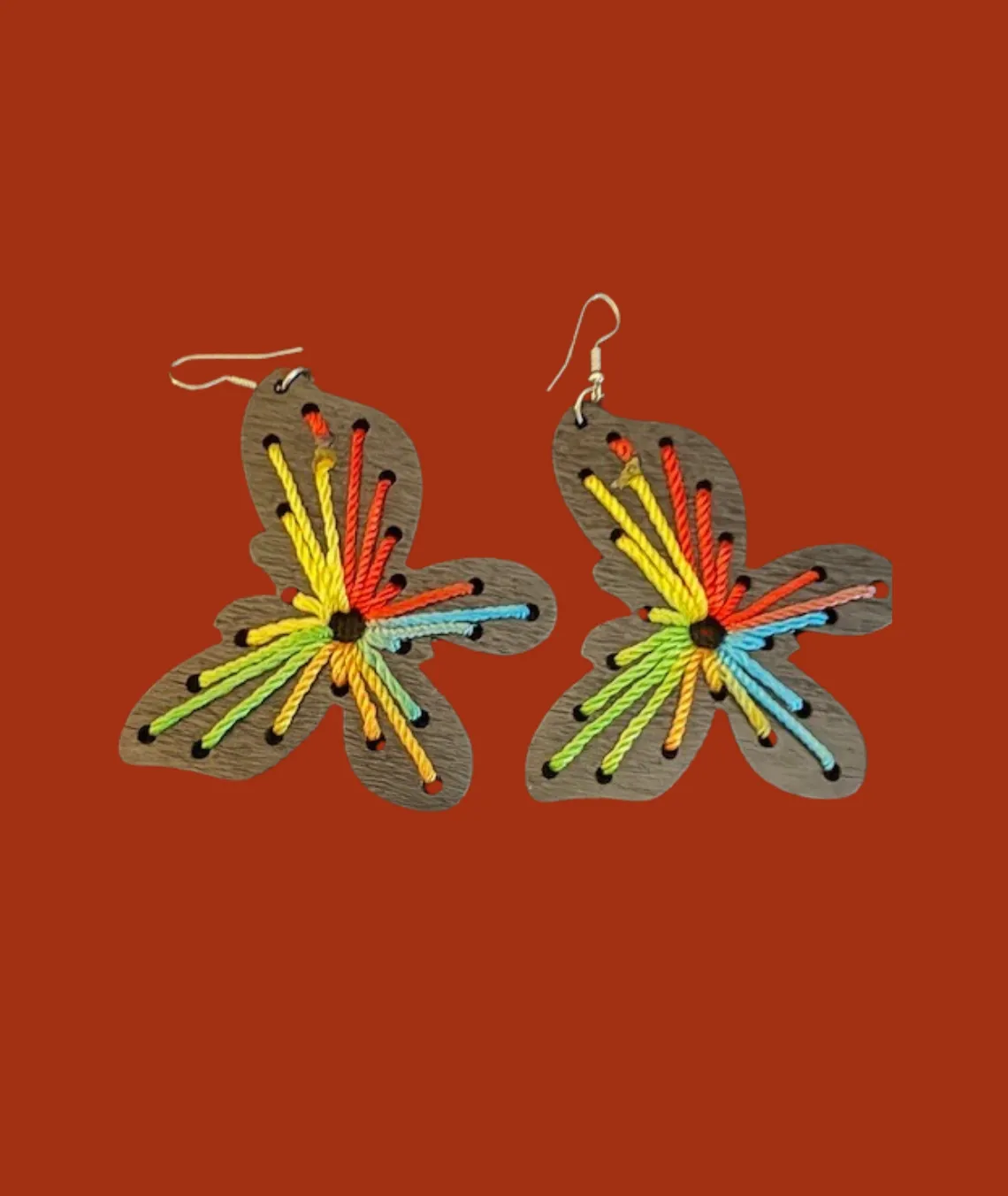 Colorful flower-shaped wooden earrings with vibrant thread embroidery