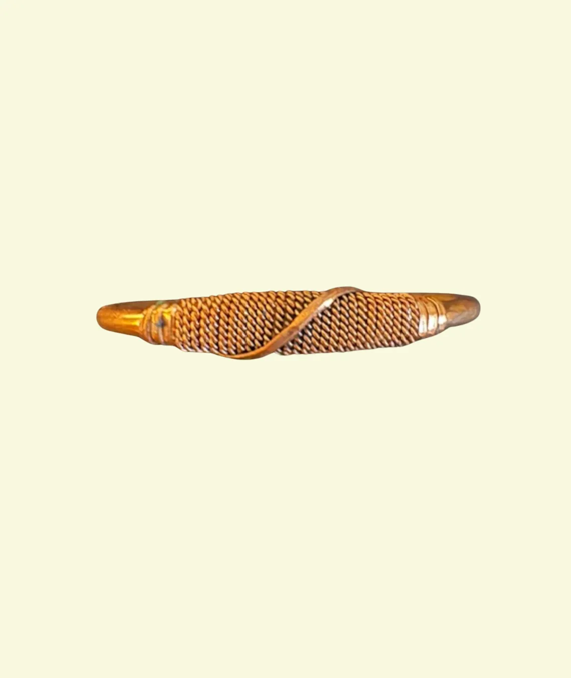 Golden metallic twisted bracelet with intricate woven pattern