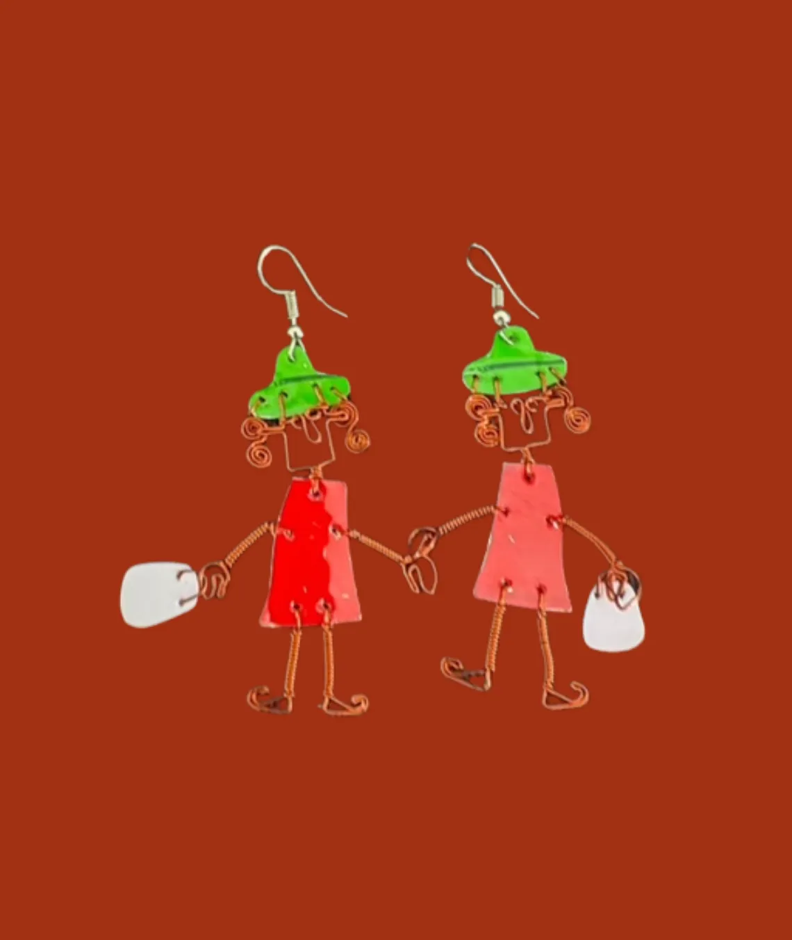Whimsical wire earrings shaped like two holding hands with green hats