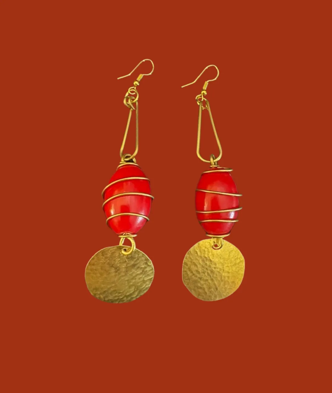 Gold-wrapped red bead earrings with textured gold disc pendants