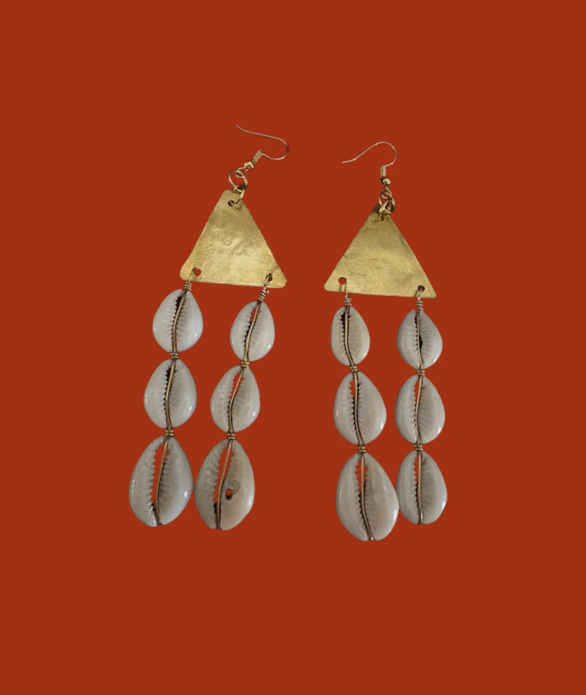 Bohemian earrings with brass triangles and hanging cowrie shell drops