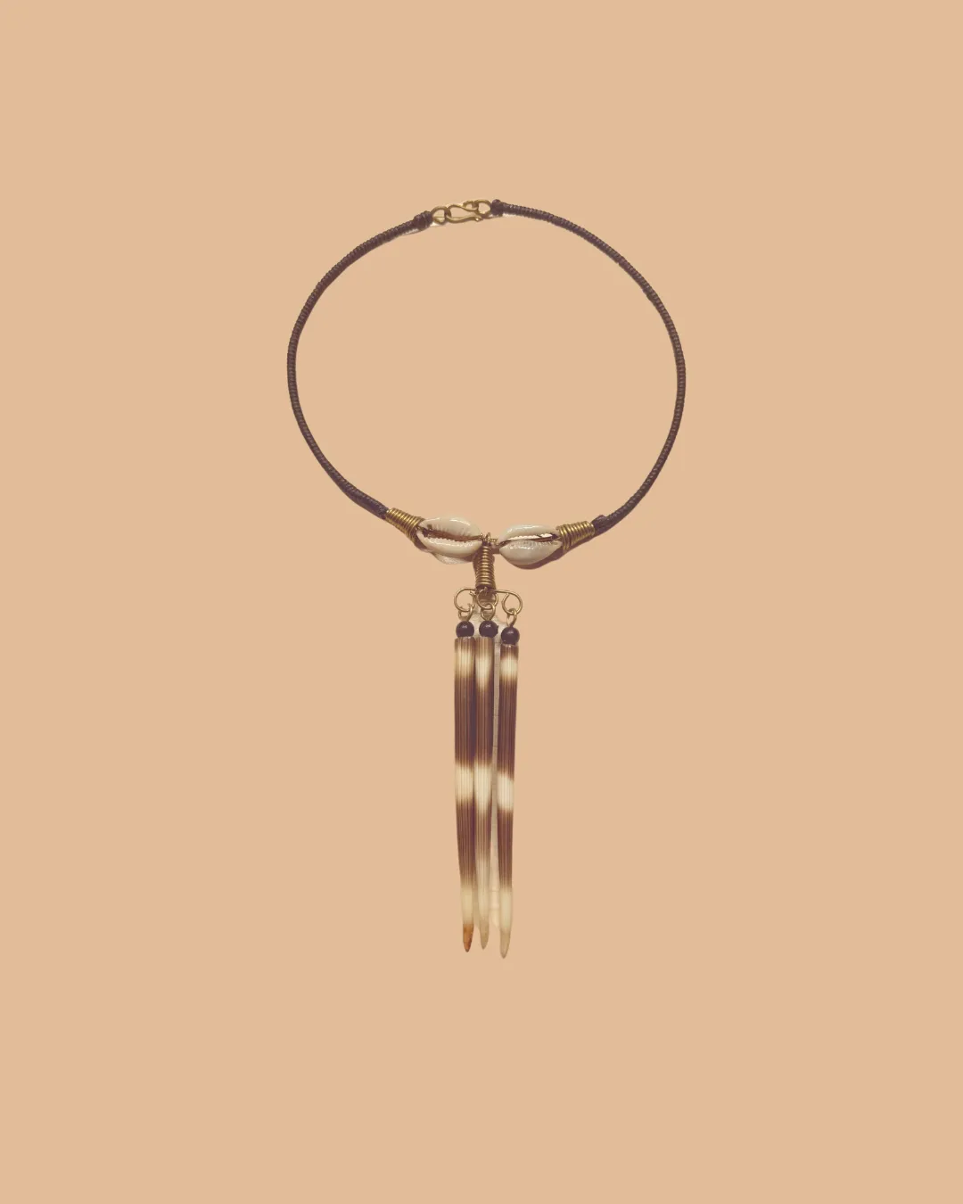 Ethnic necklace with cowrie shells and hanging tapered pendants