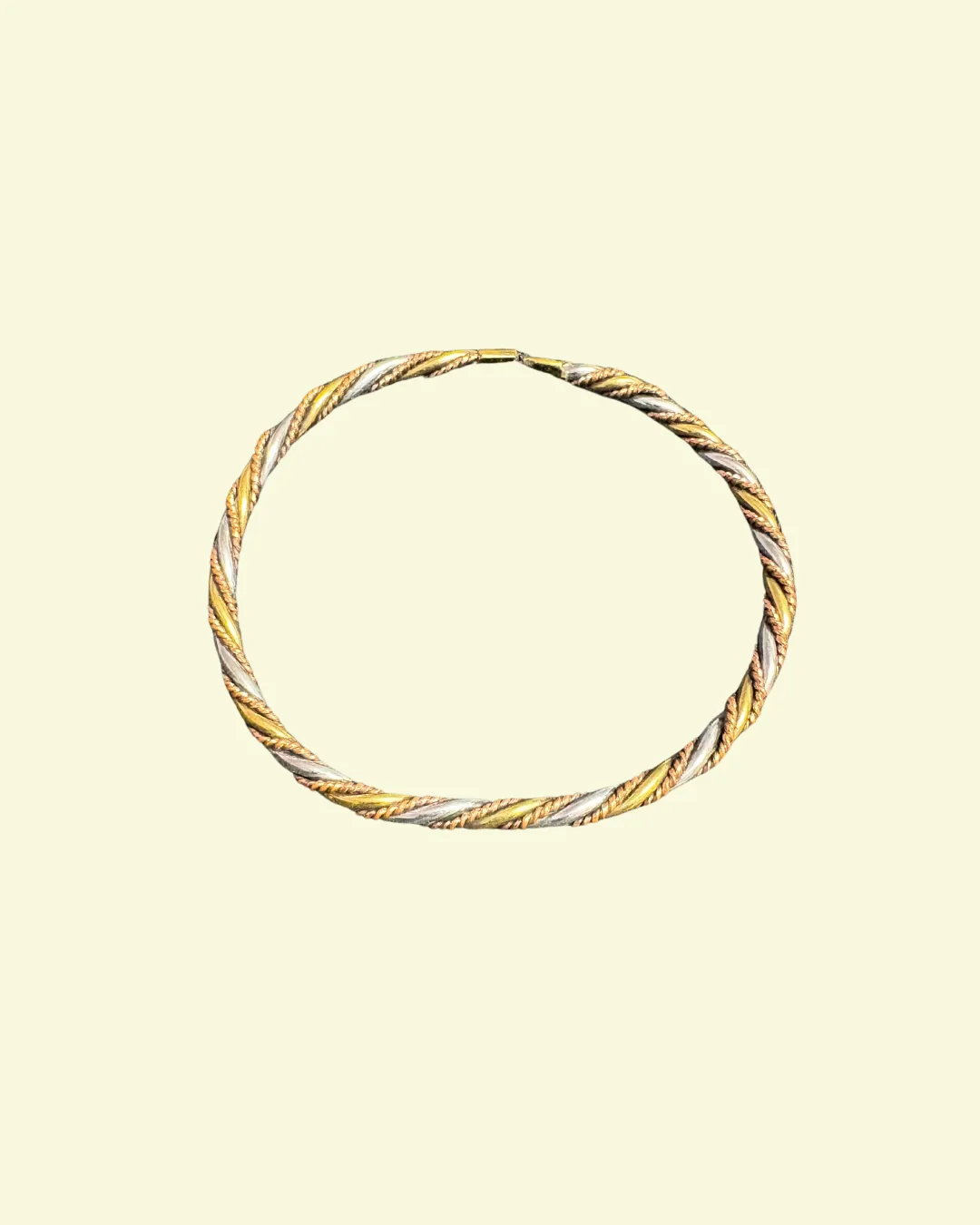 Twisted metallic bangle bracelet in gold, silver, and bronze tones