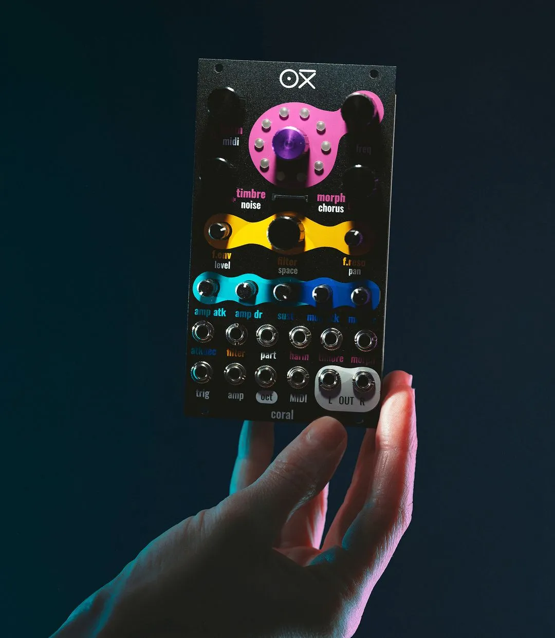 OXI Coral Eurorack synth held in a hand