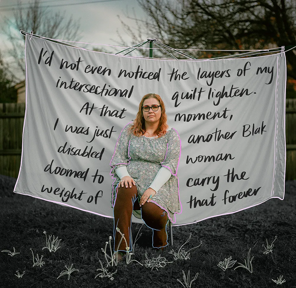A photo of Renay sitting on a stool in front of a white sheet, hung up on a hills hoist. There are words written on the sheet that read: "I'd not even noticed the layers of my intersectional quilt lighten. At that moment, I was just another Blak disabled woman doomed to carry the weight of that forever.