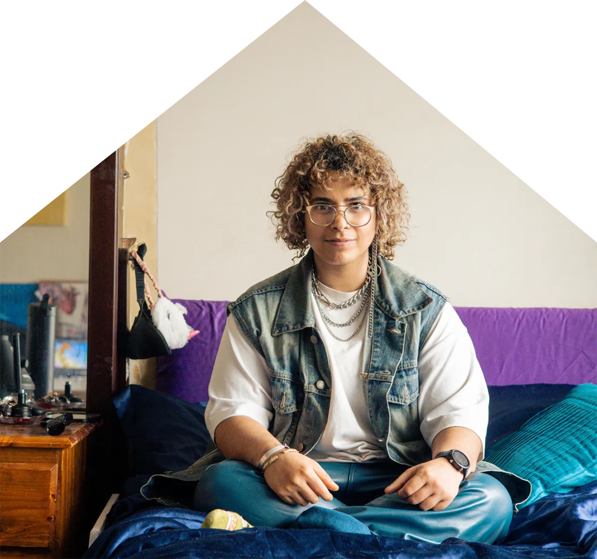 A photo of Nory sitting on their bed