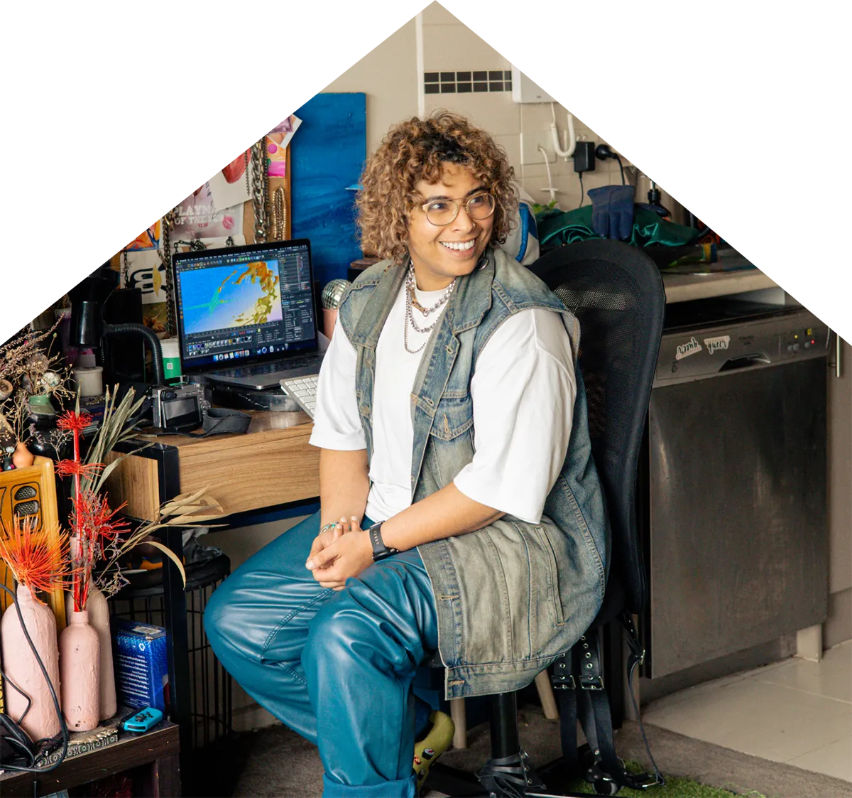 A photo of Nory sitting at their desk