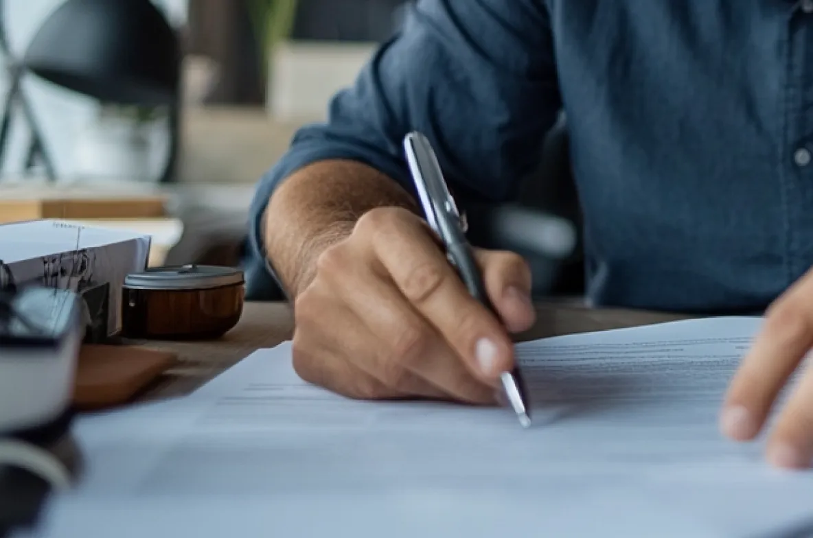 Man's hand writing on paper