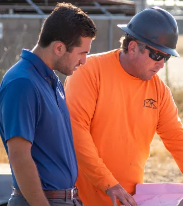 Two men looking at blueprints