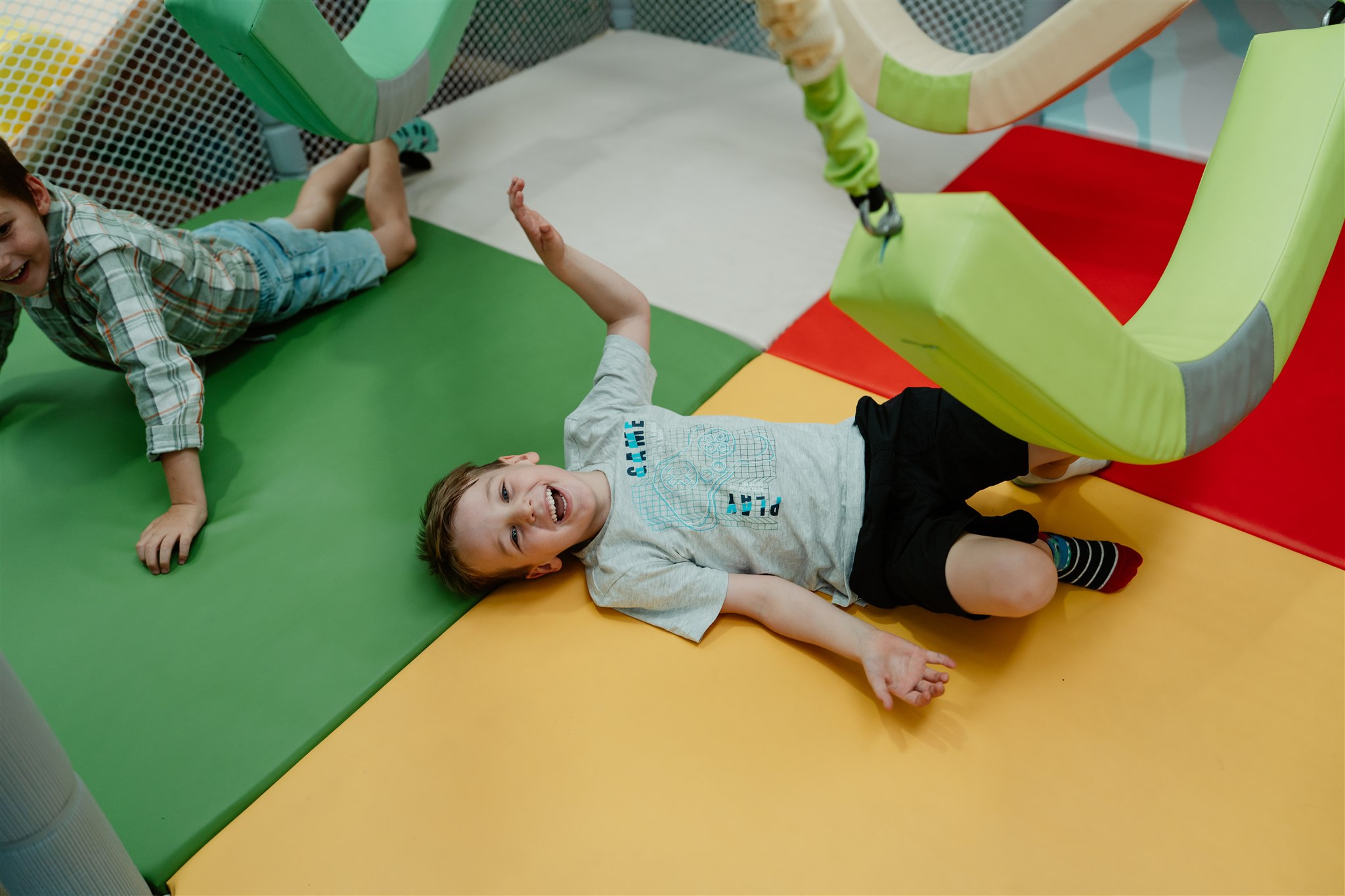 Children celebrating a birthday party with gifts and colorful confetti.