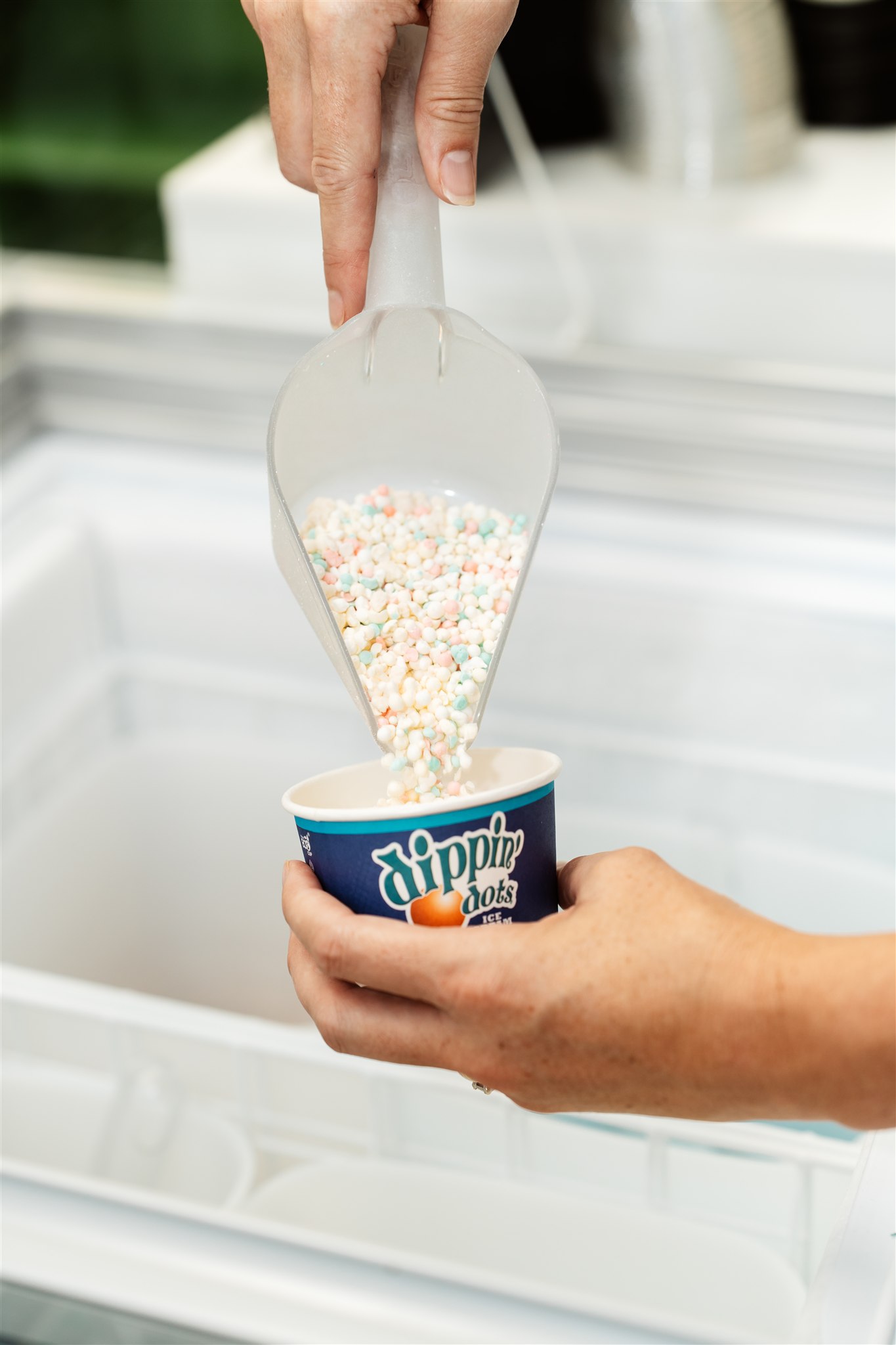 Couple enjoying coffee and conversation in cozy cafe with warm lights.