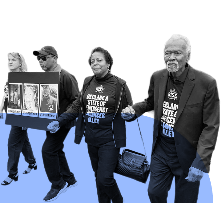 Community members march in solidarity holding hands and wearing shirts that read “Declare a State of Emergency in Cancer Alley,” calling for environmental justice and honoring those lost to pollution-related illnesses.