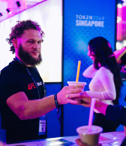 a man being handed his beverage