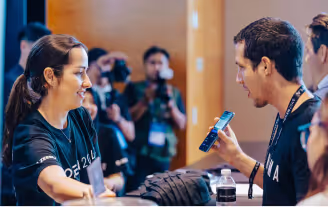 a lady looking at a man showing her his phone