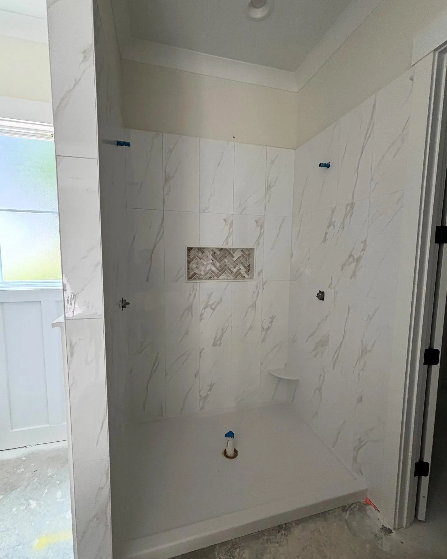 Custom tile walk-in shower in master bathroom renovation by Lee Brothers Construction in Greenville, NC
