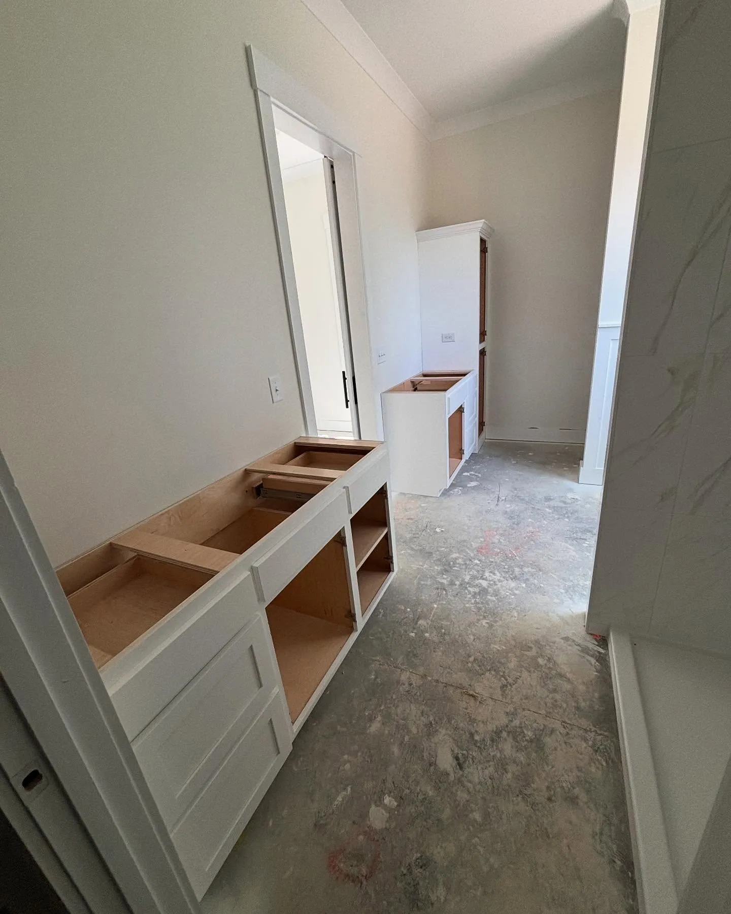 New cabinets installed in a master bathroom during a home renovation by Lee Brothers Construction in Greenville, NC.