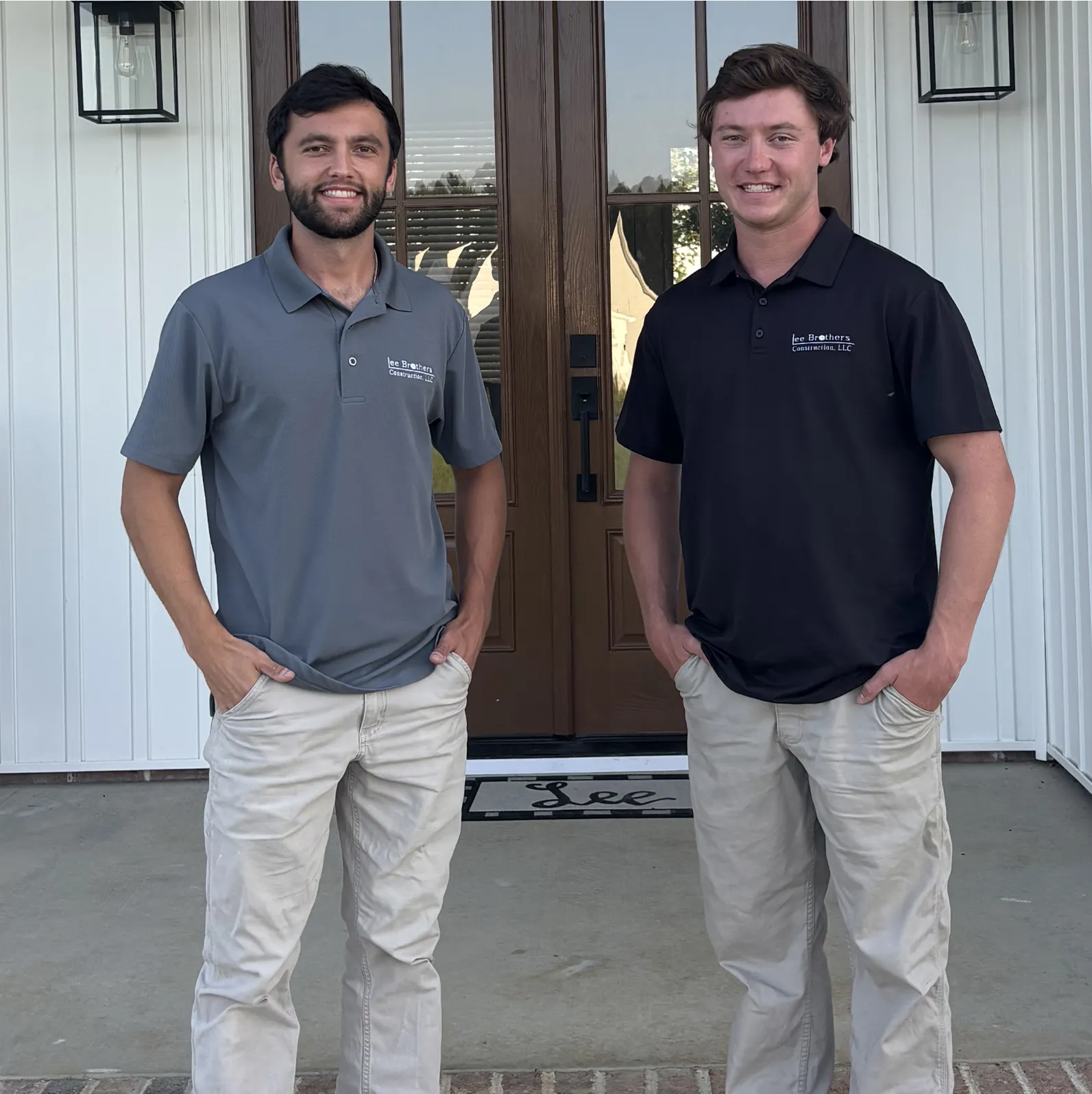 Jake and Joe Lee, of Lee Brothers Construction, standing side by side in front of a new home construction