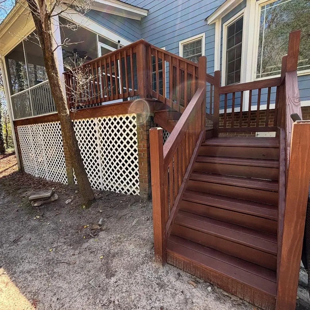 A stairway to a deck that has been renovated by Lee Brothers Construction